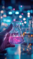A hand holding a clear glass beaker filled with water and bubbles in a laboratory setting photo