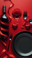 Romantic dining setup with red decor, wine, and a plate ready for a special occasion photo