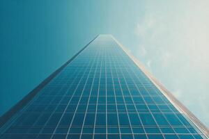 A towering skyscraper rises against a clouded sky in an urban landscape during daylight hours photo