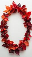 Colorful autumn leaves arranged in an oval shape on a light background for seasonal decoration photo