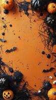 Spooky Halloween decorations featuring bats, skulls, and spider webs on an orange background photo