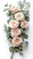 Elegant arrangement of soft peach and white roses with greenery for a spring celebration photo