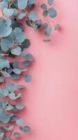 Colorful eucalyptus branches arranged on a pink background create a vibrant and serene composition photo