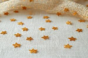 A multitude of golden stars scattered across a white background for creative decoration photo
