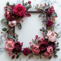 Beautiful arrangement of red and pink flowers with green leaves on a plain background photo