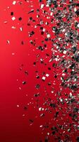 Shimmering silver confetti scattered on vivid red background for festive celebrations photo