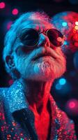 Elderly man with styled hair and sunglasses enjoying a vibrant party atmosphere during nighttime photo