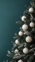 Decorated Christmas tree with white ornaments on a green background in winter celebration photo
