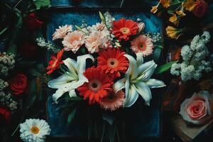 A vibrant arrangement of colorful flowers including roses, lilies, and hydrangeas in various shades photo