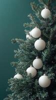 Decorated Christmas tree with white ornaments on a green background in winter celebration photo