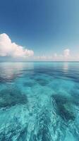 Clear turquoise water under a bright blue sky with fluffy clouds in a tropical paradise location photo