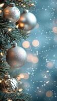 Silver Christmas ornaments hanging on a tree with blurred lights in the background photo