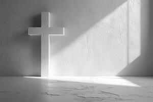 A white cross casting shadows on a textured wall in soft light during the early morning hours photo
