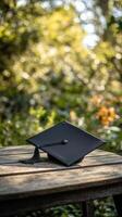 Black yoga mat rolled up on a wooden surface in a serene green outdoor environment during daytime photo
