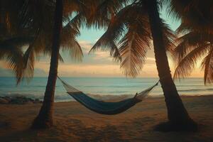Tranquil hammock resting between palm trees on a serene beach during sunset photo