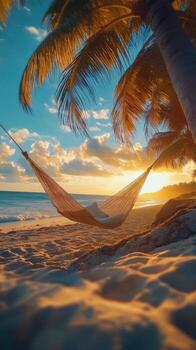 Relaxing hammock by the beach at sunset with palm trees and soft waves photo