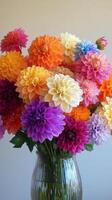 A vibrant display of colorful dahlias in a blue vase against a soft background photo