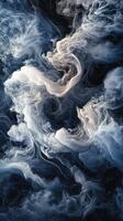 Swirling clouds of mist in shades of blue and white during twilight by a calm surface photo