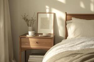 A cozy bedroom corner featuring a wooden bedside table with a cup and a vase in warm morning light photo