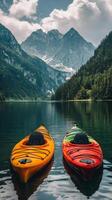 Colorful kayaks float gently on serene water amidst majestic mountains and lush forests in summer photo