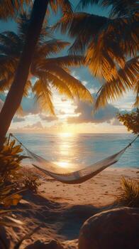 Relaxing hammock by the beach at sunset with palm trees and soft waves photo