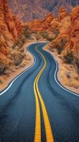 Scenic winding road through rocky desert landscape during golden hour photo