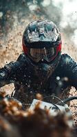 Motorcycle rider navigating through muddy terrain during an off road competition in autumn photo