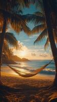 Relaxing hammock by the beach at sunset with palm trees and soft waves photo