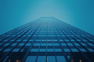 Aerial view of a towering modern skyscraper reflecting blue skies at midday photo