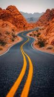 Scenic winding road through rocky desert landscape during golden hour photo