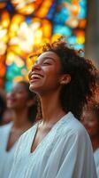 Joyful woman smiling with closed eyes in a group setting near stained glass windows photo
