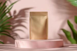 A gold packaging pouch displayed on a pink pedestal surrounded by green foliage in natural light photo