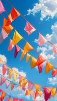 Colorful flags sway under a bright blue sky filled with clouds during a sunny day of celebration photo