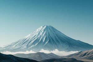 Majestic snow covered mountain peak under clear sky during winter season at sunrise photo