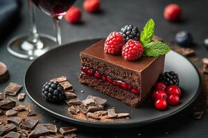 Decadent chocolate cake served with fresh berries and a glass of red wine on a dark table photo