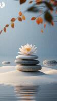 Calm waters with a blooming lotus flower on stacked stones in a serene natural setting photo