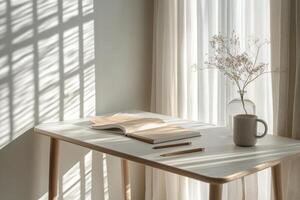 A serene workspace featuring a warm cup and neatly arranged notebooks in natural light photo