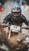 Motorcycle rider navigating through muddy terrain during an off road competition in autumn photo