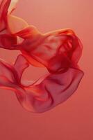 Flowing red fabric against a warm orange background creates a dynamic visual experience photo