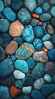 Colorful smooth stones arranged in various shades of blue and brown for decorative uses photo