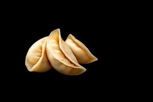 Dumplings arranged neatly against a dark background showcasing culinary artistry and texture photo