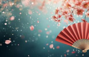Cherry blossoms and red fan create a tranquil spring atmosphere with floating petals photo