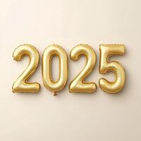Gold balloons displaying the year 2025 against a neutral background for celebration decor photo