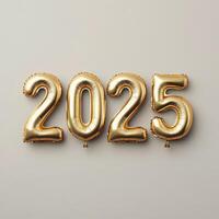 Gold balloons displaying the year 2025 against a neutral background for celebration decor photo