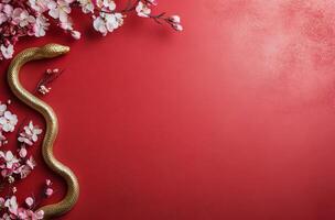 Golden snake intertwined with cherry blossoms on a vibrant red background photo