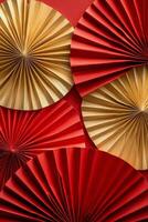 Decorative fans in red and gold arranged in a beautiful display for a festive event photo