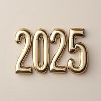 Gold balloons displaying the year 2025 against a neutral background for celebration decor photo