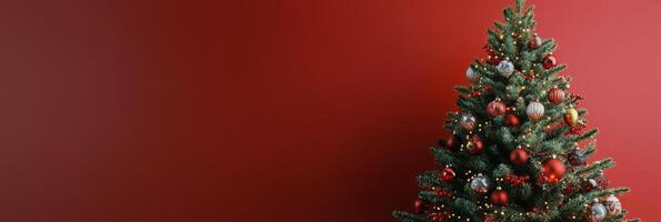 Festively decorated Christmas tree in a cozy indoor setting with a vibrant red backdrop photo