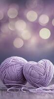 Purple yarn balls create a charming display against a soft bokeh background in evening light photo