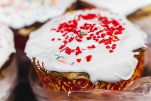 Tasty cupcakes topped with white frosting and vibrant sprinkles photo
